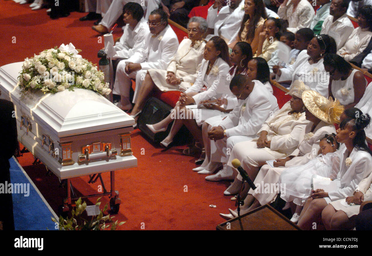 With his head bowed and hands folded, Landrin Kelly sits with family members during a public funeral for his son, Terrance Kelly, at Hilltop Community Church in Richmond, Calif., on Wednesday August 18,2004.  About 1,500 people attended the funeral for Kelly, who was gunned down in Richmond last wee Stock Photo