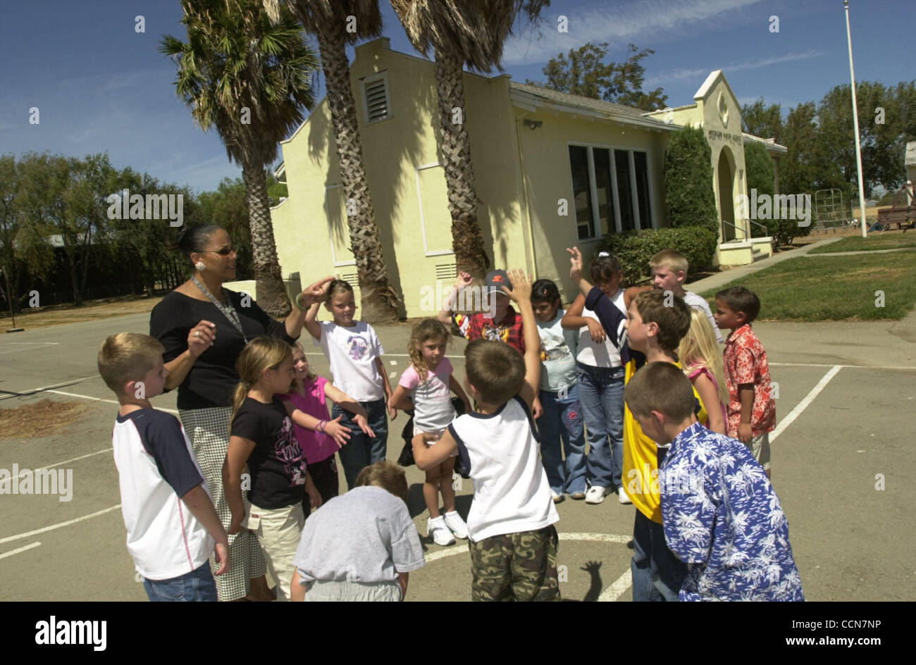Teacher Holly Sheehan gives students in her kindergarten through third grade PE class some