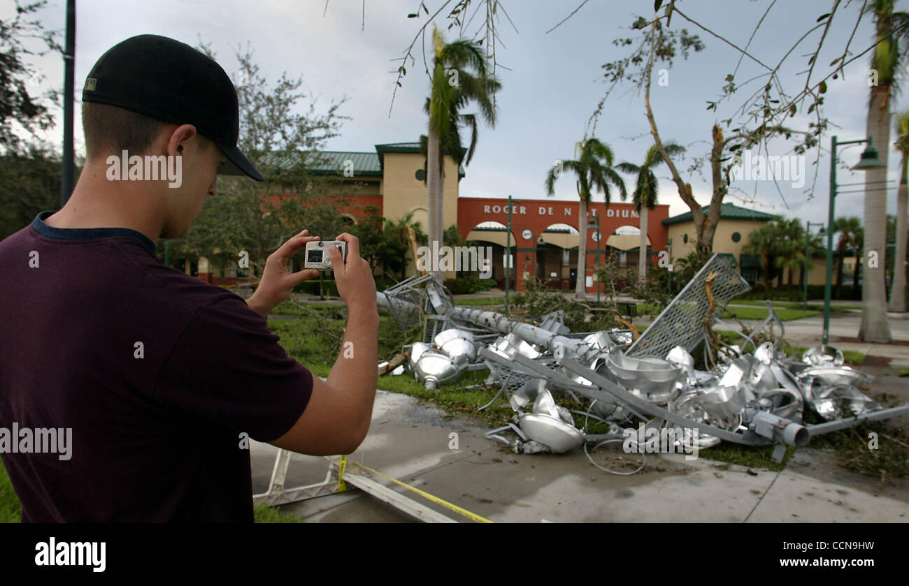 LIVE METRO--HURRICANE FRANCES--1/1--9/6/2004--JUPITER---Mike West, 19, of Jupiter photographs one of the lightpoles at Rodger Dean Stadium, Monday afternoon. Several were blown down during the storm. Staff photo by Bob Shanley. Stock Photo