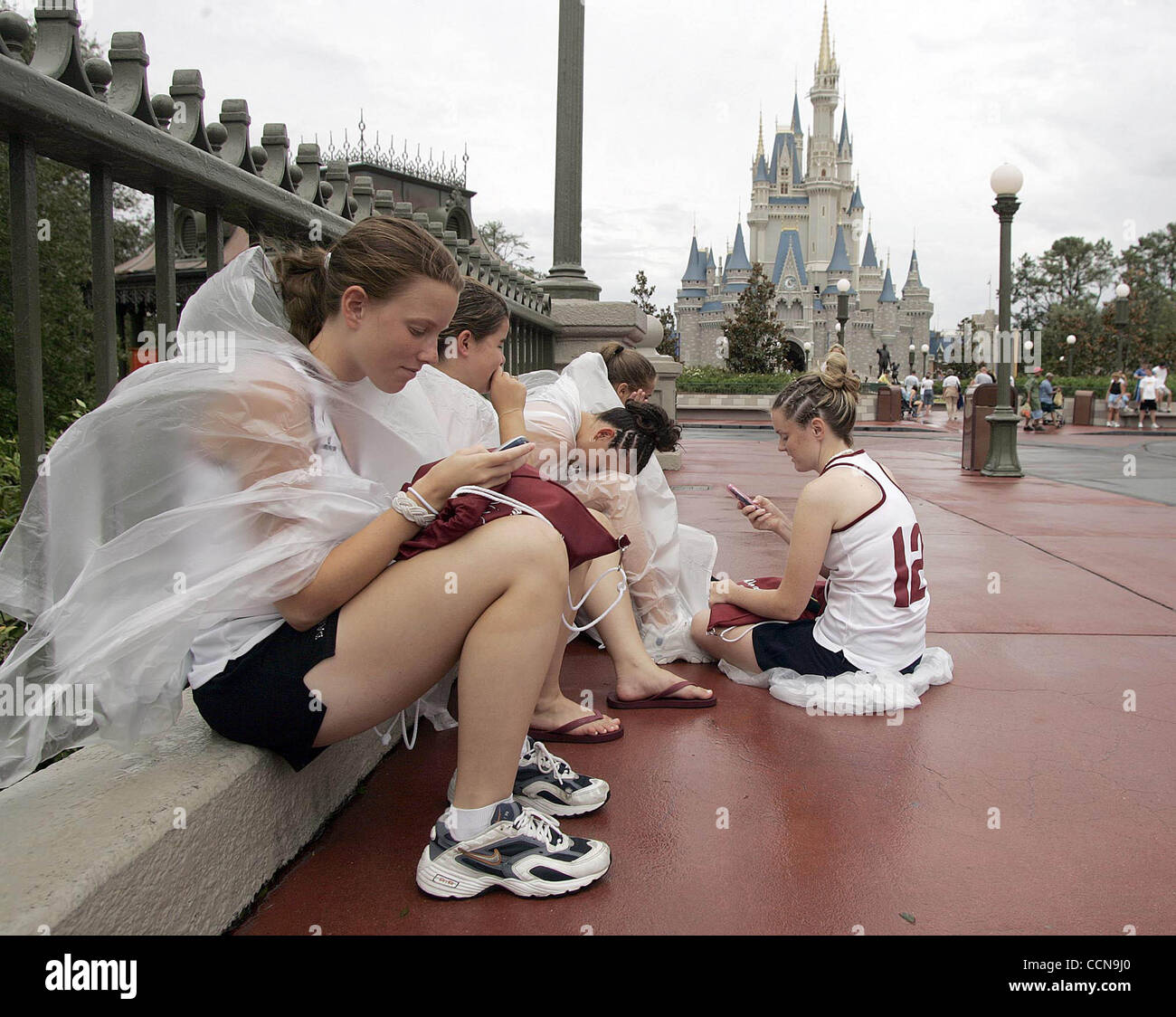 Nicole Plouffe, 14,  of Woonsocket, RI sends a text message while taking a break with her field hockey teammates in front of Cinderella's Castle Monday, Spetember 6, 2004 at the Magic Kingdom in Lake Buena Vista, FL.  (Photo by Chris Livingston/for the Post) Stock Photo