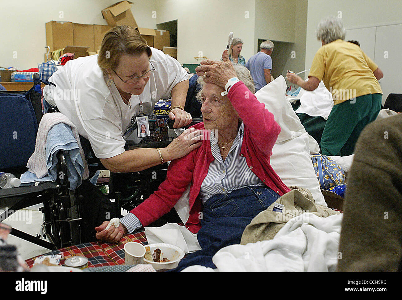 PORT ST LUCIE - Sally Palladino, a human services counselor, checks on Mary Laveck inside hurricane shelter set up at the Port St. Lucie Community Center.  Laveck, who has had both of her legs amputated (?sp?), has been in the shelter since Thursday with her husband Joseph.   Photo by Damon Higgins/ Stock Photo