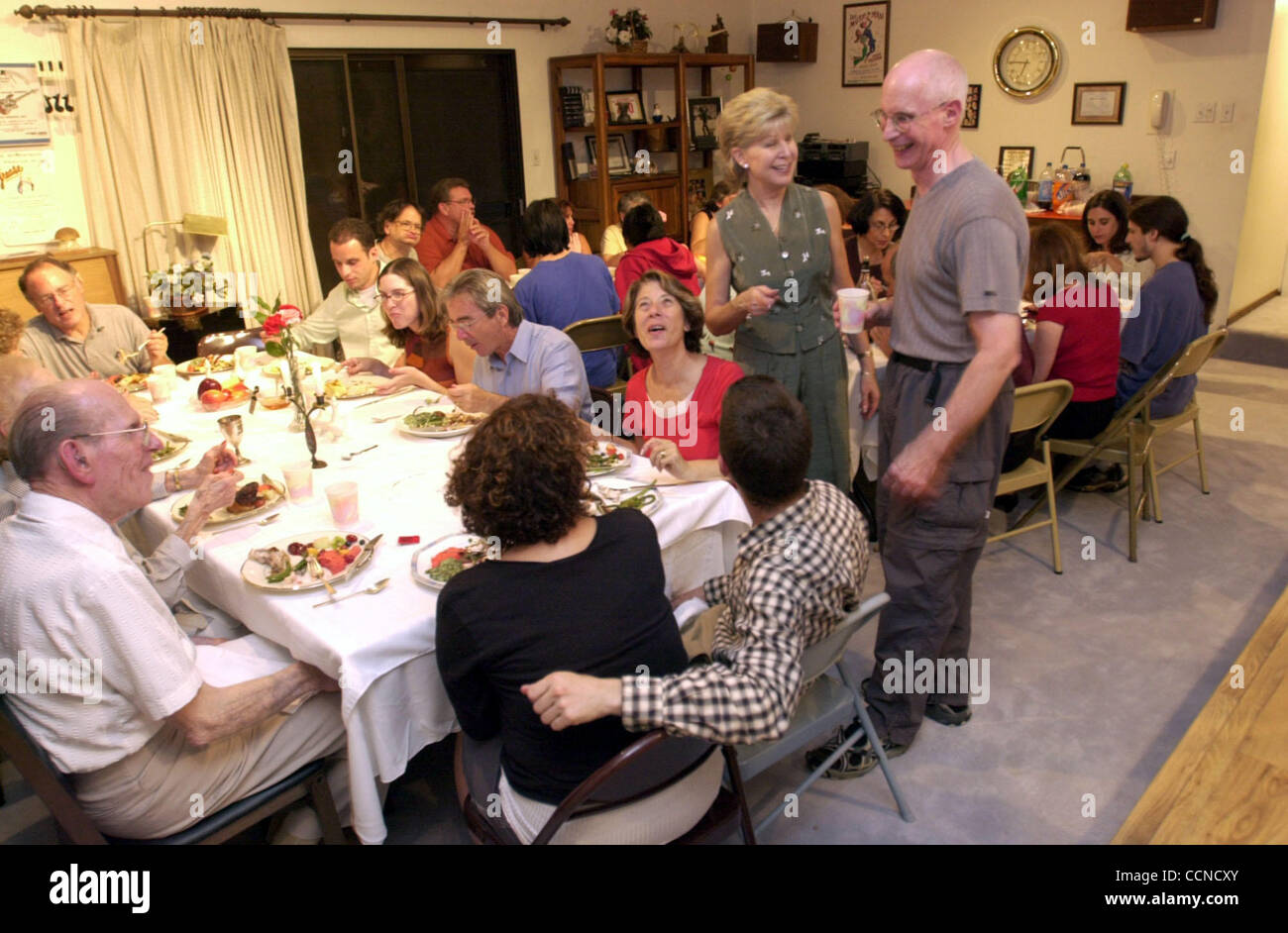 7:47PM.  Diane Kamrin and her brother Michael Harris laugh with guests at their Rosh Hashana dinner for friends and family on Thursday September 16, 2004 in Pleasant Hill, Calif.   (Contra Costa Times/ Gregory Urquiaga) Stock Photo