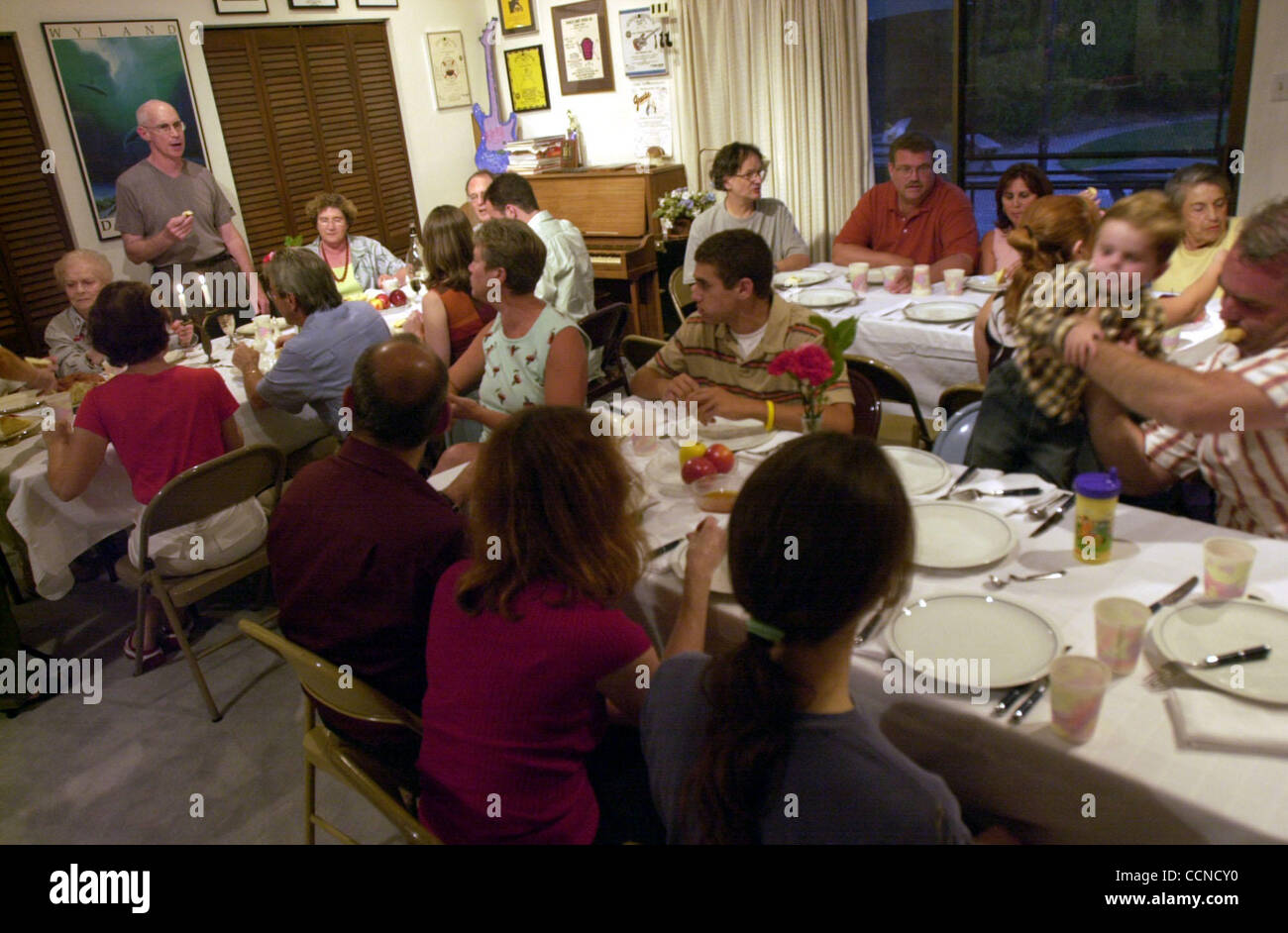 7:28PM.  Robert Harris (standing) leads the traditional prayer with guests at Rosh Hashana dinner for friends and family on Thursday September 16, 2004 in Pleasant Hill, Calif.   (Contra Costa Times/ Gregory Urquiaga) Stock Photo