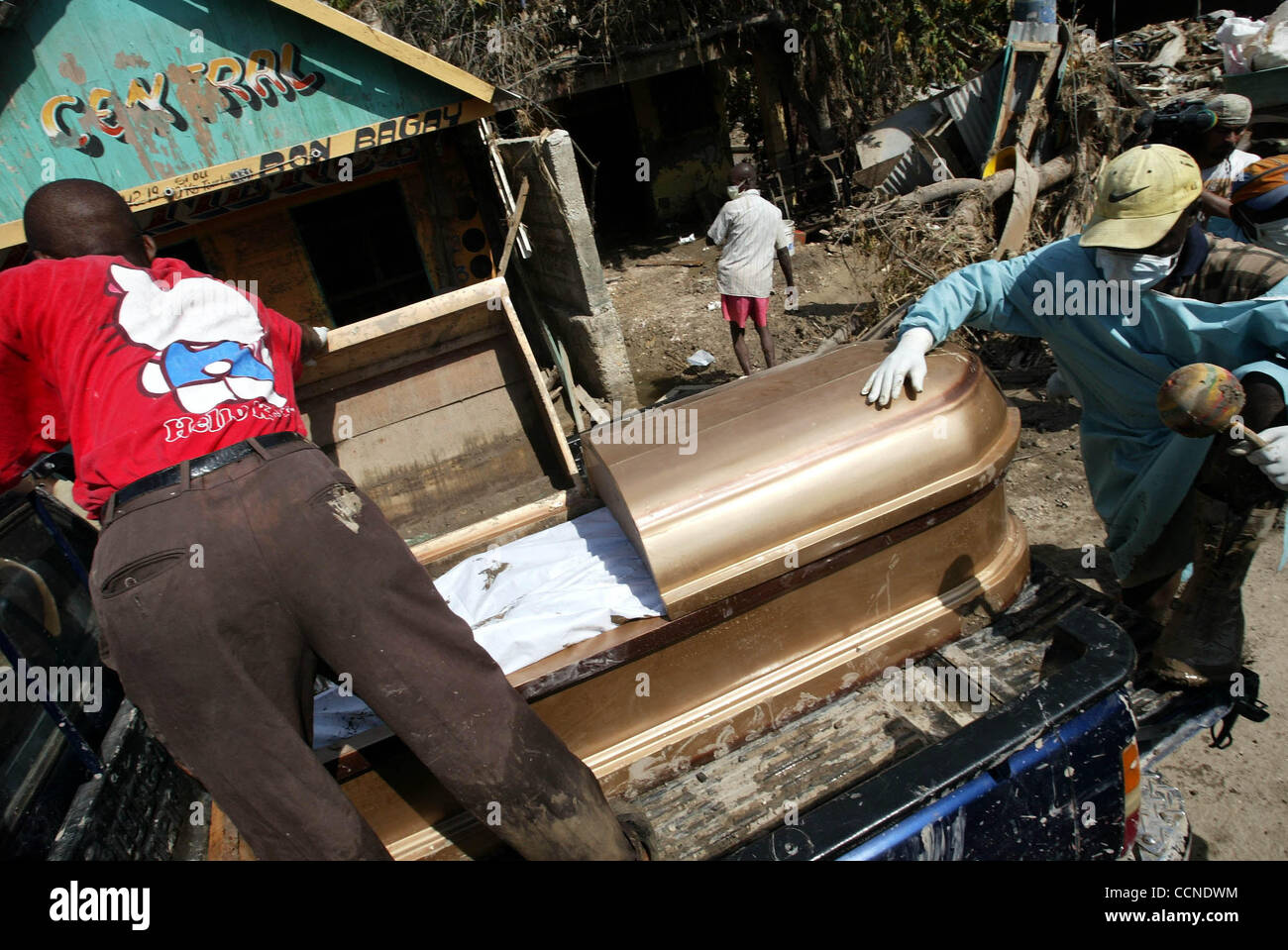 Sep 24, 2004; Gonaives, HAITI; Funeral home workers load the body of a man recovered from his home Friday morning in Gonaives after the flooding days ago from Hurricane Jeanne. The man, Ascanio Toussaint, was found by his daughter when she broke down the door to his home.  She had heard that he had  Stock Photo