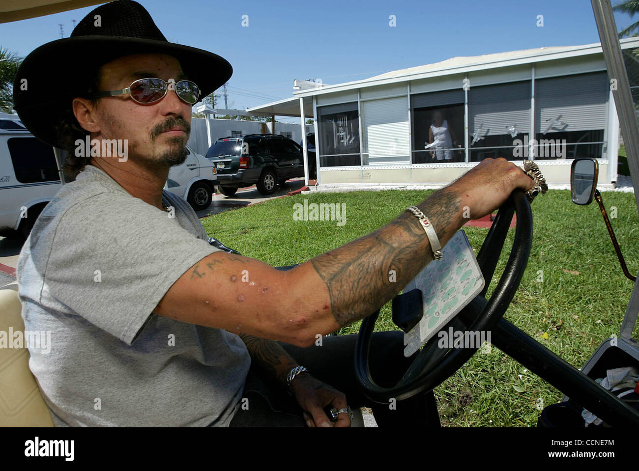 092704 met jeanne--Port St. Lucie. --Tiim Shay rides around in his golf cart in the Spanish Lakes mobile home where he lives looking to help others and invite them to his home for ice , water and food. staff photo by Greg Lovett Stock Photo