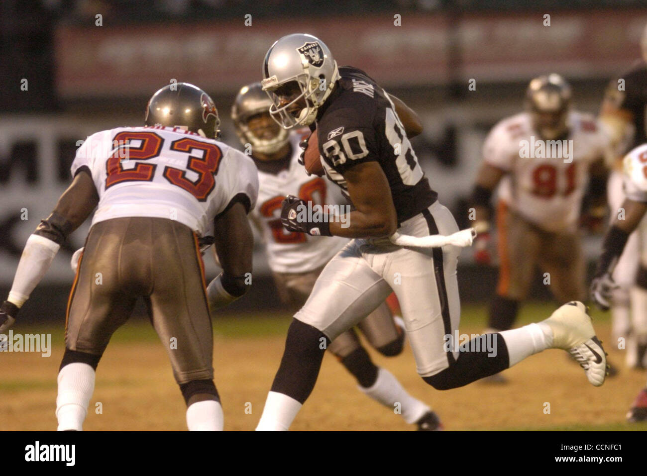 Raider receiver Jerry Rice (right) runs with the ball after making a ...