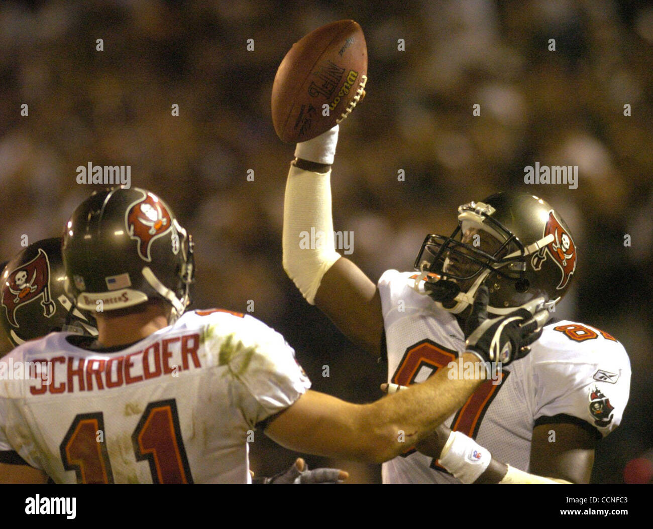 Tampa Bay Buccaneers receiver Tim Brown (right) celebrates his 100th TD