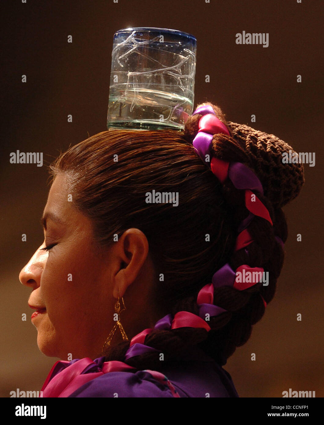 Marisela Castaneda, from Antioch, balances a glass of water on her head as she dances with members of the ballet folklorico group Olin de Contra Costa during a performance for the National Hispanic Heritage Month festivities at the Somersville Town Center on Sunday, October 3, 2004 in Antioch, Calif Stock Photo