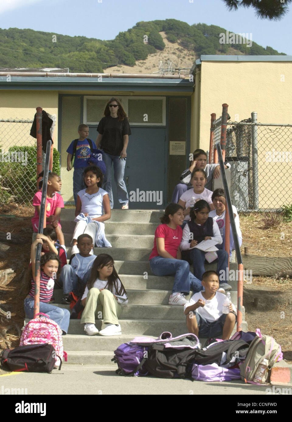 Students wait on the steps at Olinda School to picked up after school