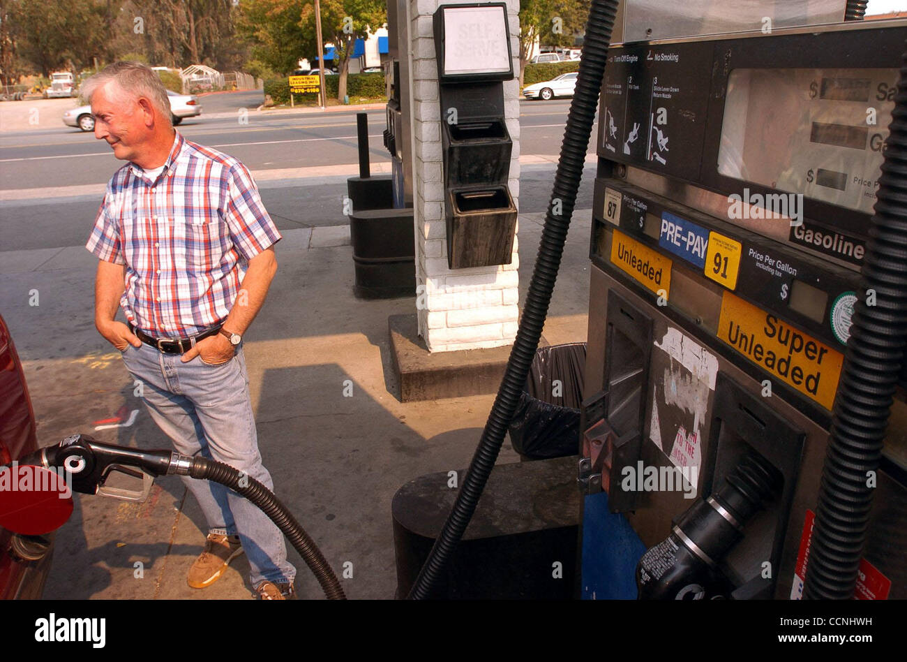 Bob Brunner from Oregon fills up with $80 in gas at 5 Star Gas Station which was the cheapest gas in the area on Thursday October 14, 2004 in Martinez, Calif.   One of the reasons Brunner bought his Ford Excursion was because it took regular gas.  As gas price reach new heights in California, people Stock Photo