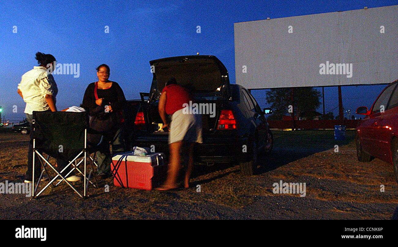 STATE/ADVANCE/ WESMER THEATRE: Sol Rodriguezunpacks her car ans friends Mary Ann Ramierz and Lily Zepeda mess around before the start of 'The Grudge' movie at the WesMer Drive-Inn Friday Oct.29, 2004. DELCIA LOPEZ/STAFF Stock Photo