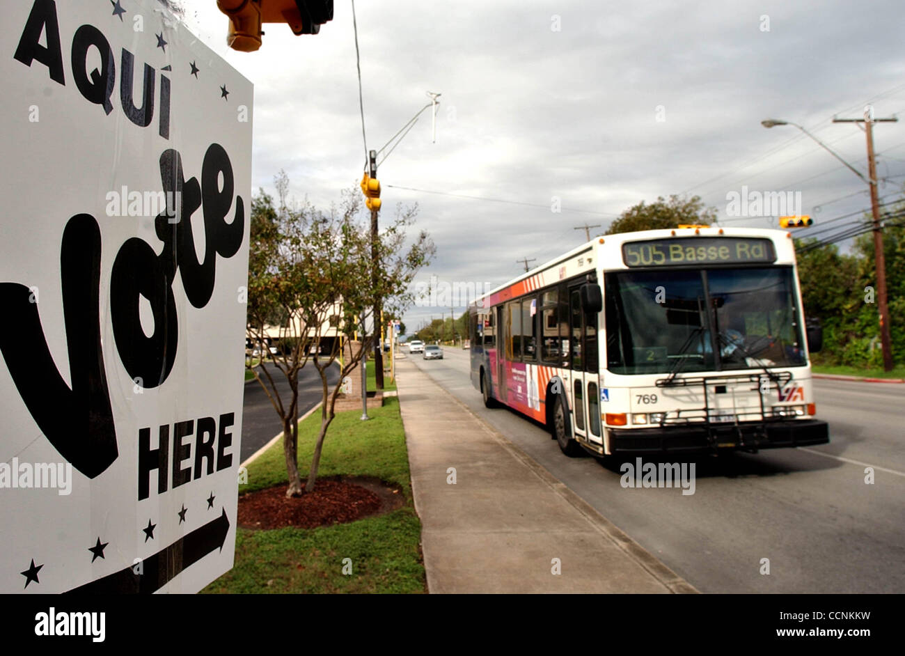 A VIA bus passes by the Alamo Height Administration Building polling