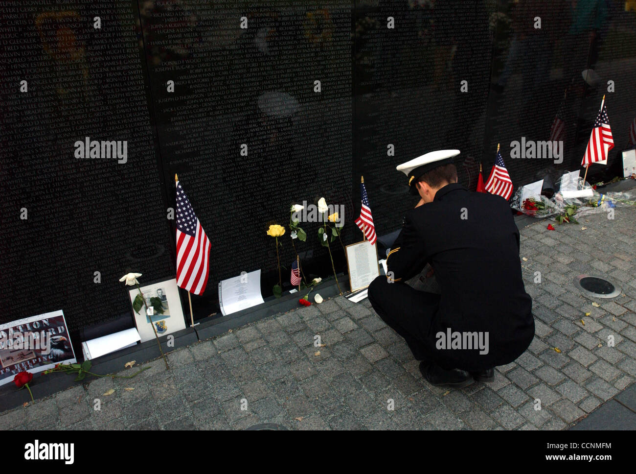 Slug:Steele VeteransDay2004 20 Date:11/1104 Photographer: Rick Steele Caption: Ensign Joe Cantras, USN, reads over the names on the Wall. Veterans from WWII, Korea, Vietnam and both Desert Storm Wars convereged on the capitol to celebrate Veterans Day. Stock Photo