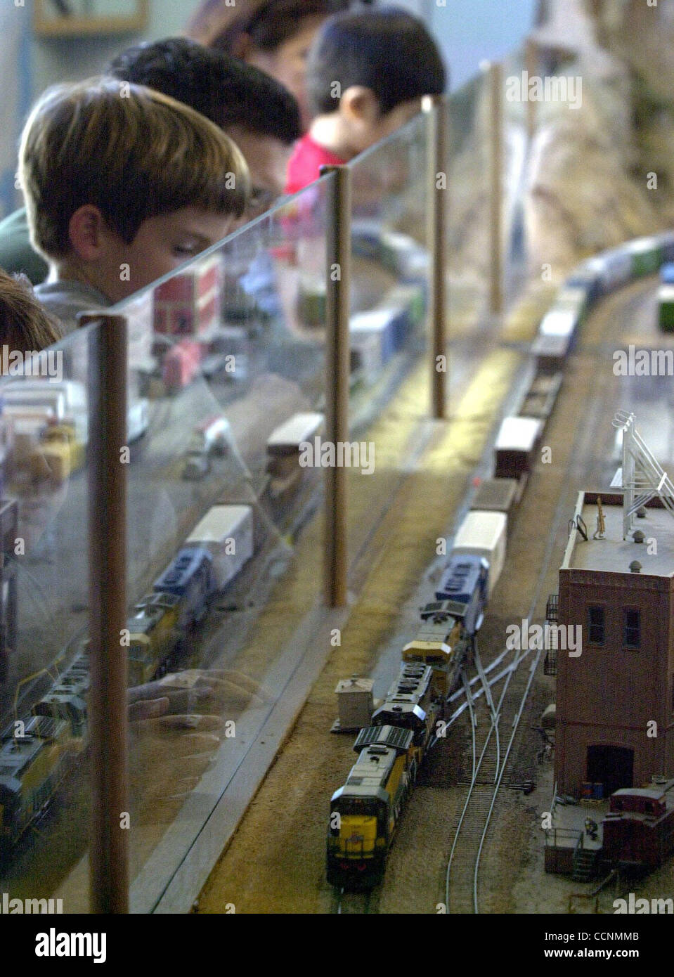 Model train enthusiasts watch the HO scale railroad trains roll down