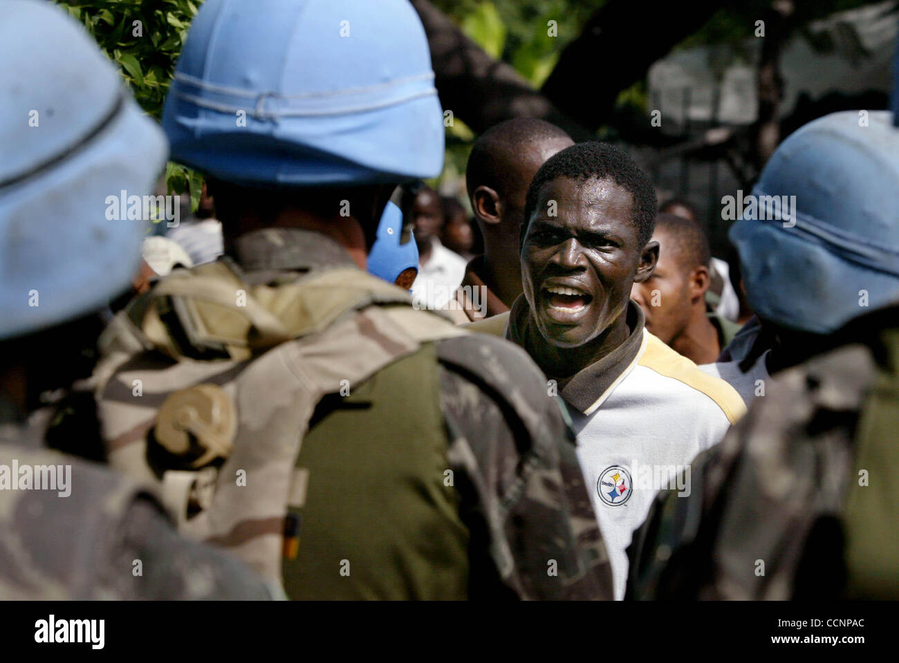 111804 met haiti 30--Petionville, Haiti--A Haitian argues with members of the United Nations peacekeeping force to allow Haiti's ex-military force to parade through the streets of Petionville on their way to the National Palace on Nov. 18, 2004, Haiti's 200-year anniversary of independence from the  Stock Photo