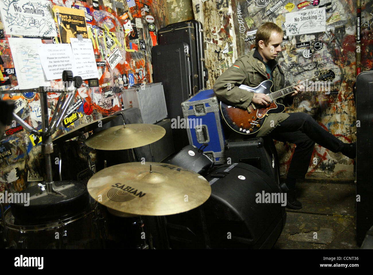 Oct 24, 2003; Manhatten, NY, USA; TED LEO of the 'Ted Leo Band' preforms at CBGB's on the Bowery in Manhattan for the CMJ music festival. Ted practices some tunes backstage and does some streches before going on stage. Ted Leo, guitar and vocals, Dave Lerner, bass, Chris Wilson, drums. Stock Photo