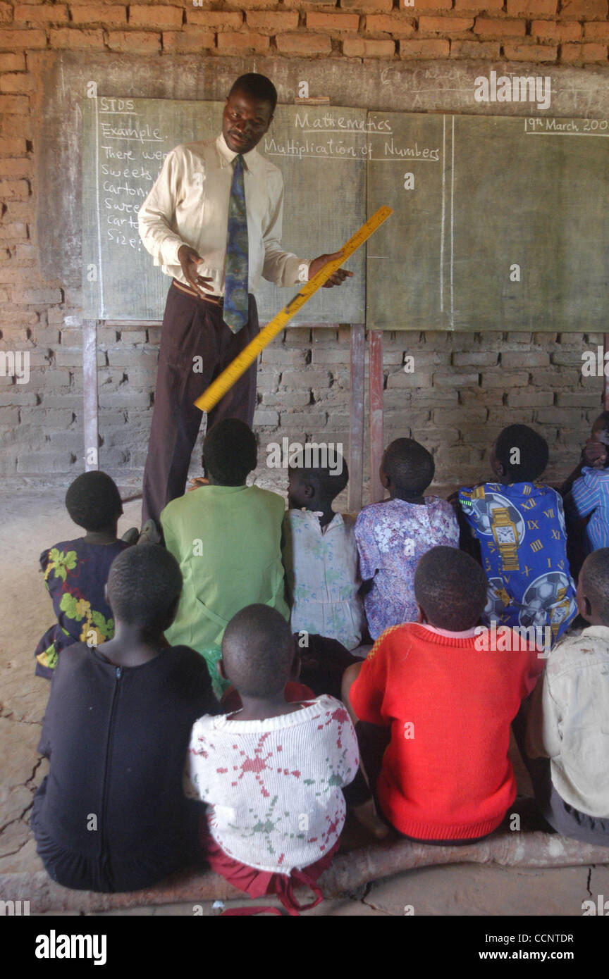 March 18, 2004, Bala, Malawi A young male teacher uses a ruler and a
