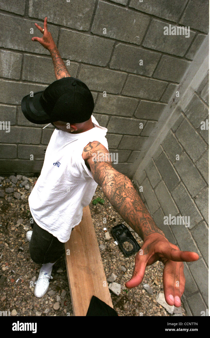 Lucifer, a 22-year-old member of the 18th Street gang who was sentenced to 17 years for murder, displays his tattoos as he stands in a cellblock in a federal prison outside Tegucigalpa, Honduras.   Photographer:  Luis J. Jimenez City: Tegucigalpa Country: Honduras Date: June 10, 2004 Stock Photo