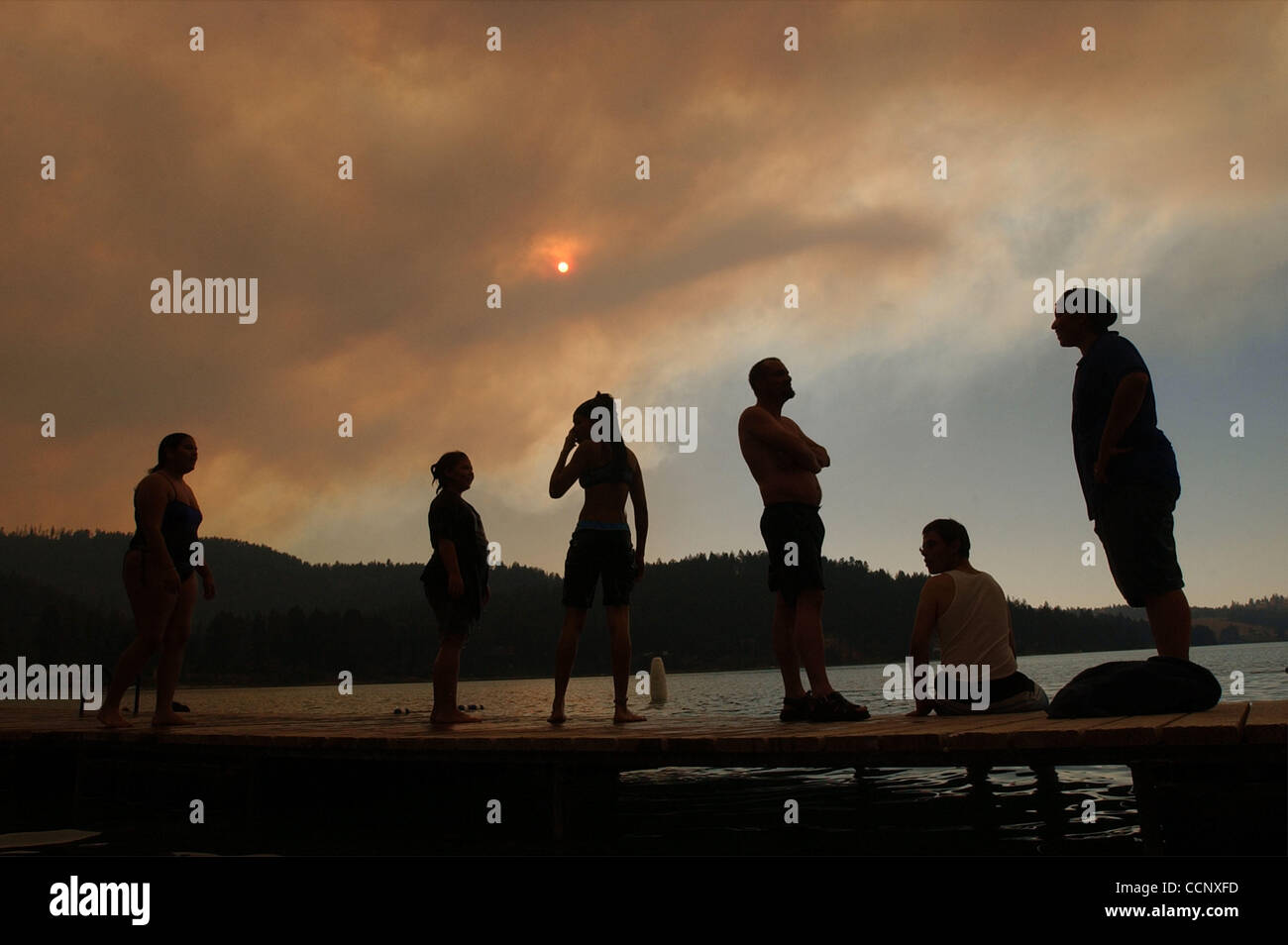 Aug 10, 2003; Kalispell, Montana, USA; Swimmers stand on a dock at Foys Lake near Kalispell