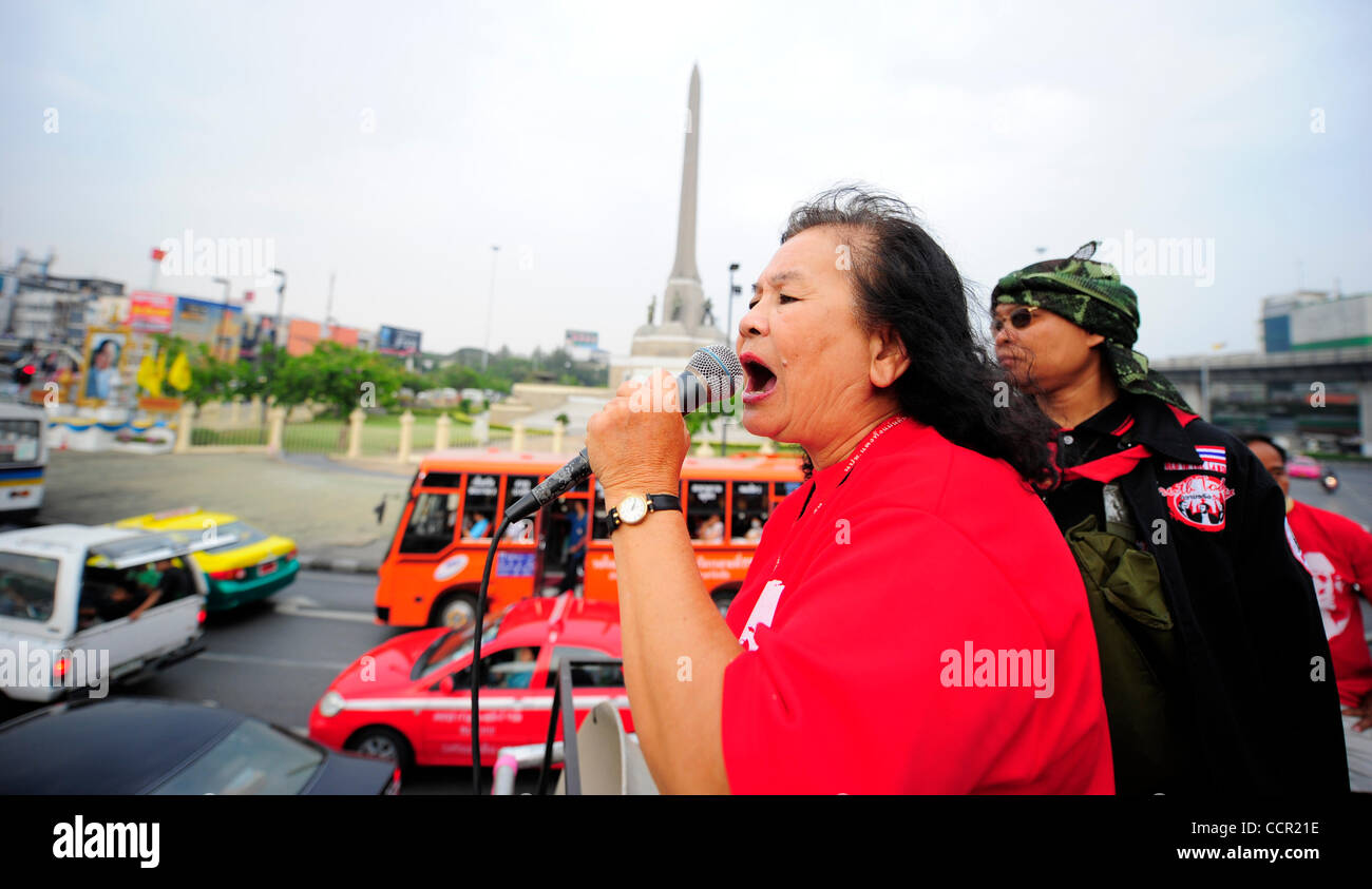 A Red Shirt rides on a truck equipped with speaker system asks Bangkokian to joint the protest. Motorcade carry Red Shirts drive through streets of Bangkok to roust out support from Bangkokians. Red Shirts have gathered to pressure Prime Minister Abhisit Vejjajiva to stand down and call for new elec Stock Photo