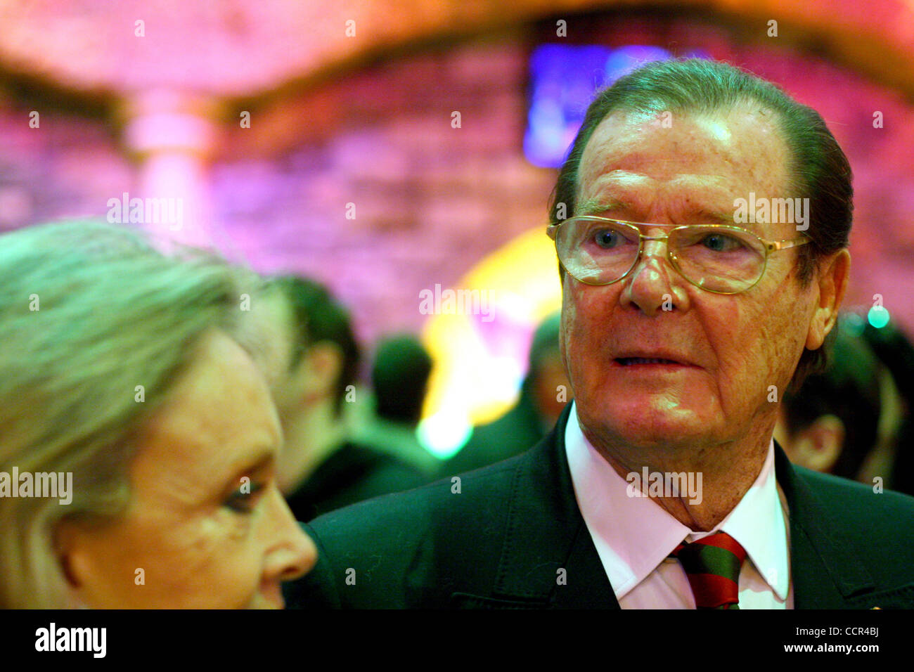 Famous British actor Sir Roger Moore, who is well known for the portrayal of the legendary secret agent James Bond, has visited Russia. As the honorary ambassador of the United Nations Childrenís Fund - UNICEF, Sir Roger Moore (pictured with his wife Kristina Tholstrup ) took part in the opening of  Stock Photo