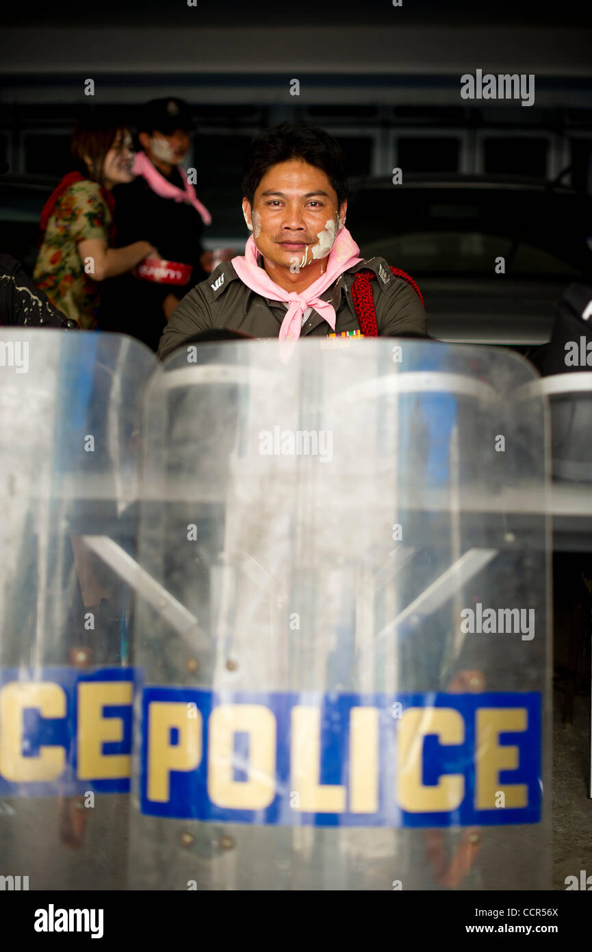 A policement with powder on his face during the Songkran festival at Ratchaprasong intersection in Bangkok. Red Shirts, also known as United Front of Democracy against Dictatorship (UDD), supporters of ousted Prime Minister Thaksin Shinawatra celebrate the first of three days Songkran festival afte Stock Photo