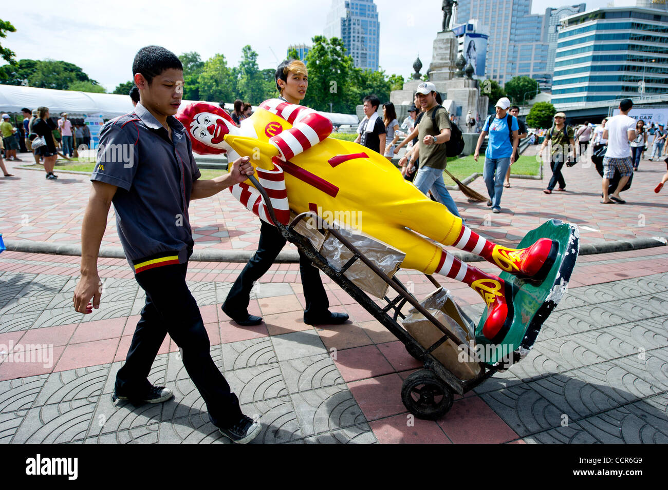 McDonald's employees transport Ronald McDonald Statue during massive clean up after crackdown operation finally evicted the Red Shirts protesters after pro-long protest in Bangkok's financial and shopping district. Stock Photo