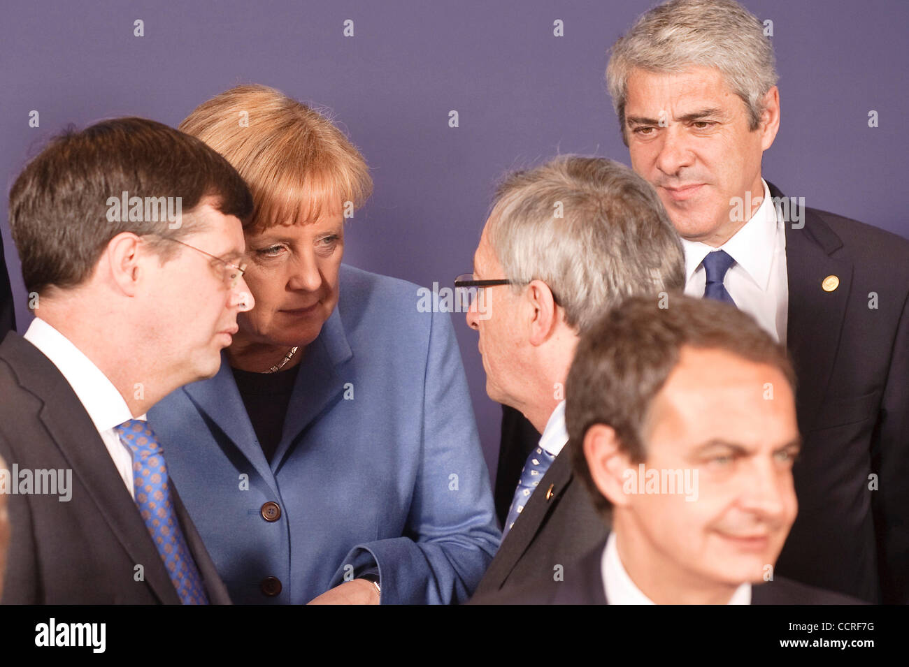 (L-R)   German Chancellor Angela Merkel (C) , Dutch Prime Minister Jan Peter Balkenende (L) and  Luxembourg's Prime Minister Jean-Claude Juncker chat during a group photo at an EU summit  in  Brussels, Belgium on 2010-03-25  European leaders are facing a moment of truth at a Thursday summit, as mark Stock Photo