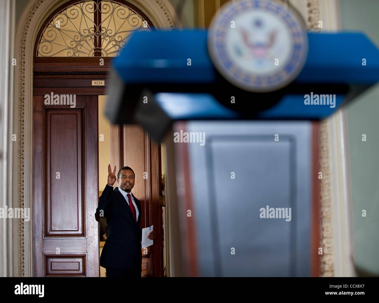 May 26, 2010 - Washington, District of Columbia, U.S., -  Senate Majority Leader Harry Reid's Press Secretary Rodell Mollineau, signals three minutes to the waiting media before the start of a press conference introducing the co-chairs of the National Commission on Fiscal Responsibilty and Reform. ( Stock Photo
