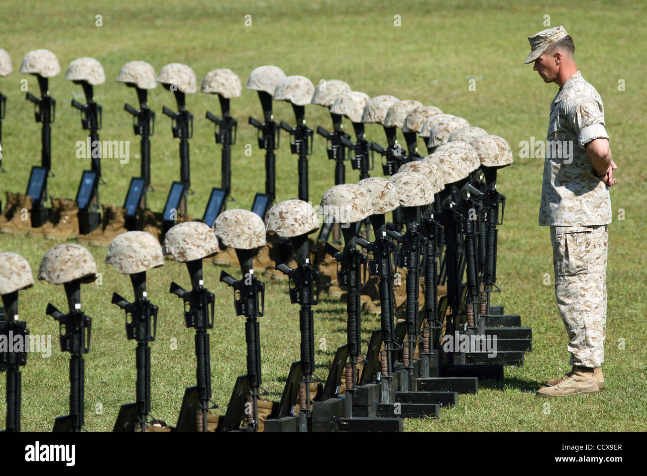 CAMP LEJEUNE, NC  - APRIL 30:  Major Mike Weber stands at attention in front of the 90 memorials at the 2nd Marine Expeditionary Brigade service honoring the unit’s Marines and sailors killed during their recent deployment to Afghanistan on Friday, April 30, 2010 in Camp Lejeune.The 2nd MEB deployed Stock Photo