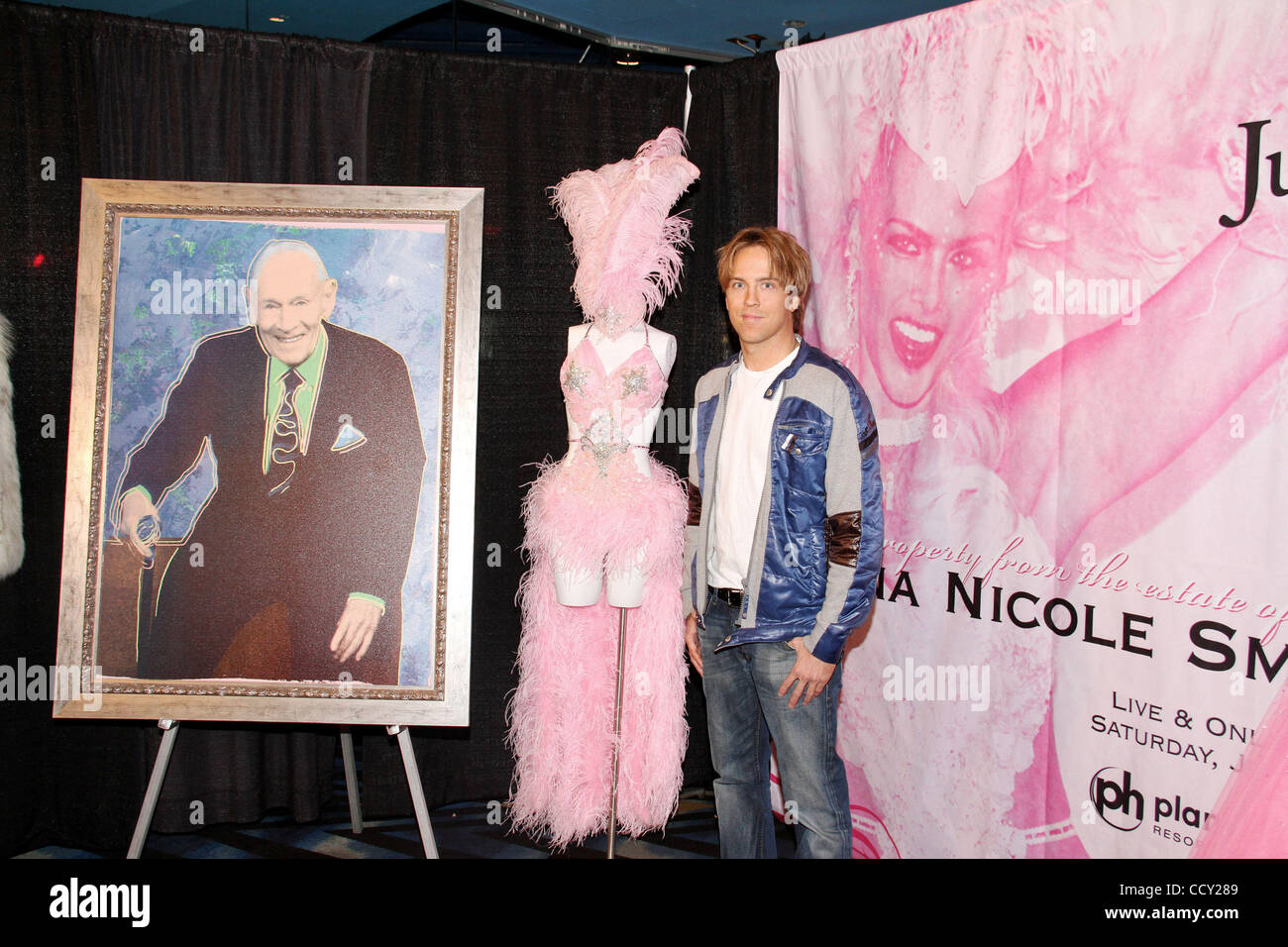 Photographer (R) LARRY BIRKHEAD stands next to a (C) costume worn by  his former partner ANNA NICOLE SMITH during a 2004 Halloween Party at the Playboy Mansion and an (L) original screen print portrait of Anna Nicole's former husband J. Howard Marshall. Items sold will  benefit his daughter Danniely Stock Photo