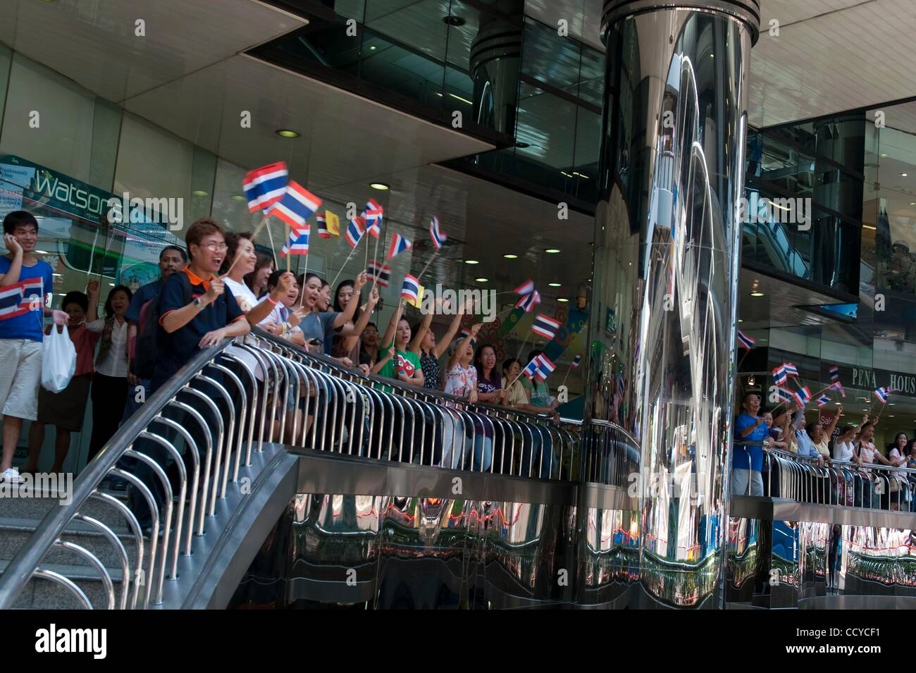 Apr 19, 2010 - Bangkok, Thailand - People wave Thai flags distributed by the 'No Color Shirts' campaign in support of the governemnt  during the massing of forces to secure Bangkok's financial district. Thai Army and Thai Royal Police have been deployed to the financial district to safe guard it as  Stock Photo