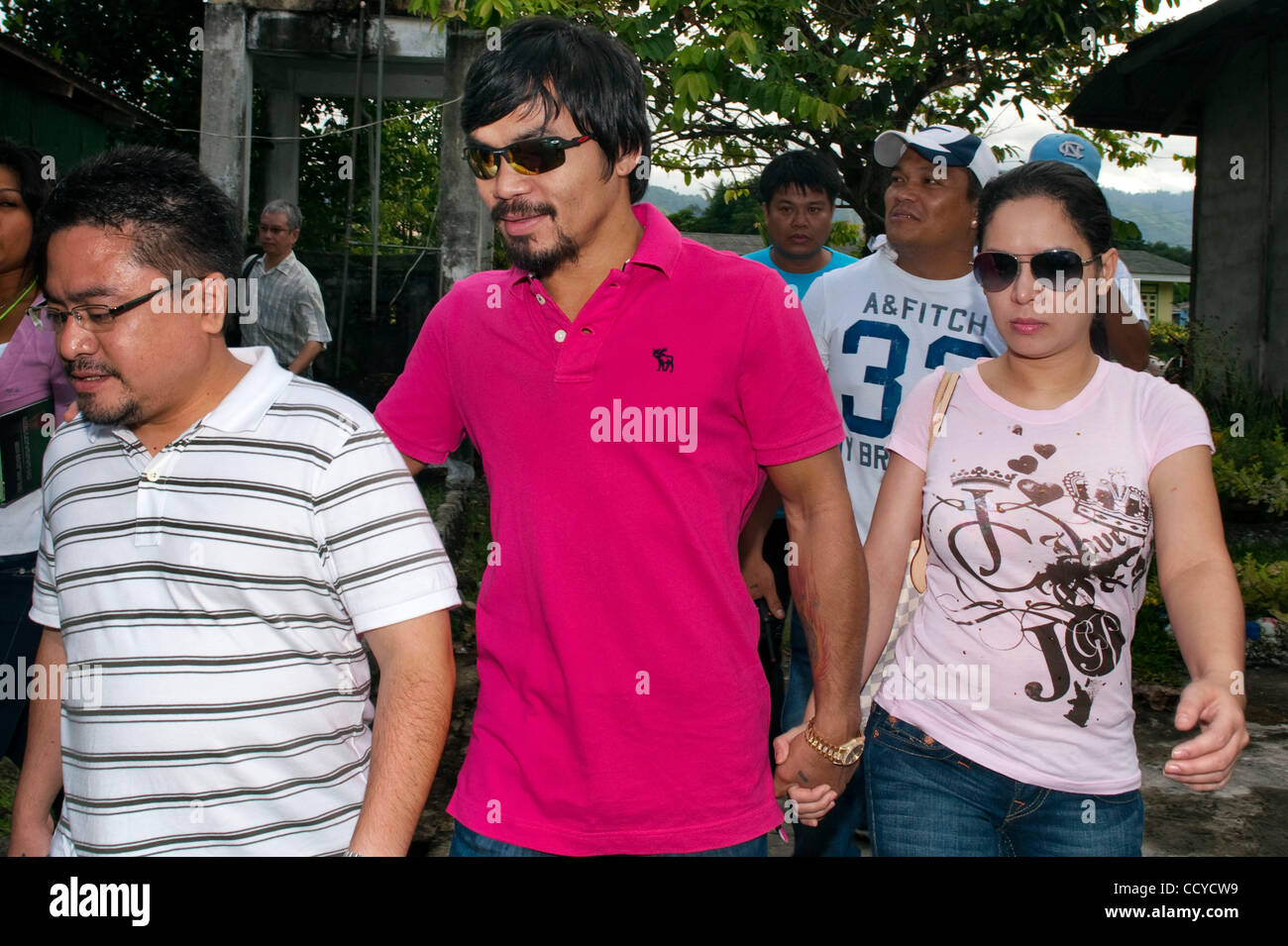 May 09, 2010 - Kiamba, Sarangani, Philippines - Boxing champion Manny Pacquiao accompanied by his wife Jinkee arrives at the polling station on 10 May 2010 in Kiamba, Sarangani Philippines..Manny Pacquiao is running for the congressman..For the first time some 50 million Filipinos will have a chance Stock Photo