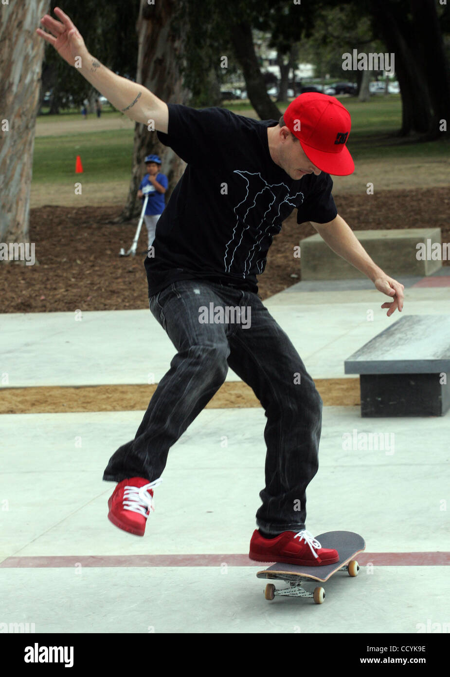 Skateboarder Rob Dyrdek is skating at the grand opening of a skate park