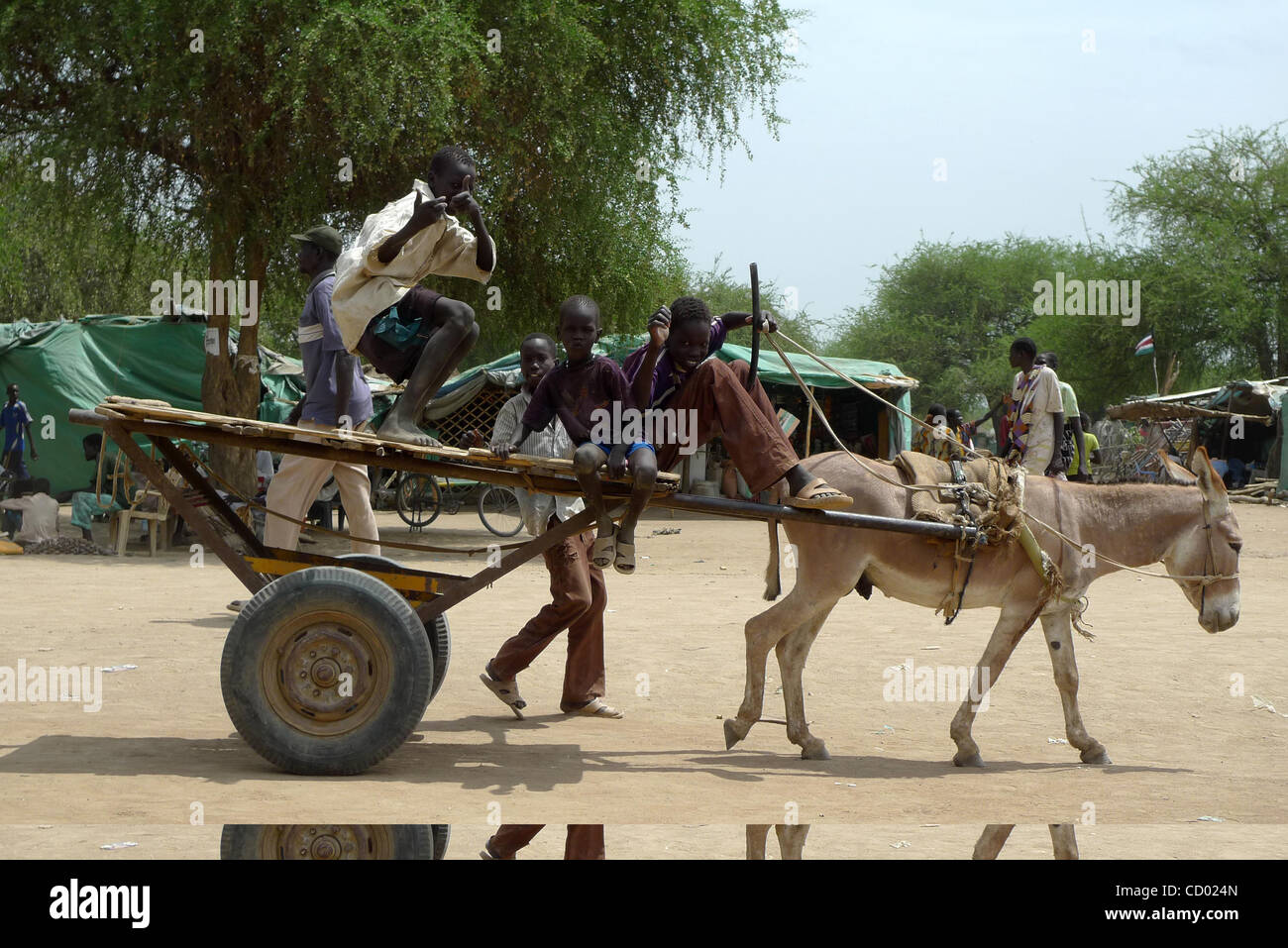 Mar 13, 2010 - Turalei, Sudan - Sudanese kids ride through Turalei on a donkey-pulled cart. Sudan will hold its first democratic elections in 24 years starting April 11 as part of a 2005 peace agreement signed between the Arab north and the African south after decades of civil war.  (Credit Image: © Stock Photo