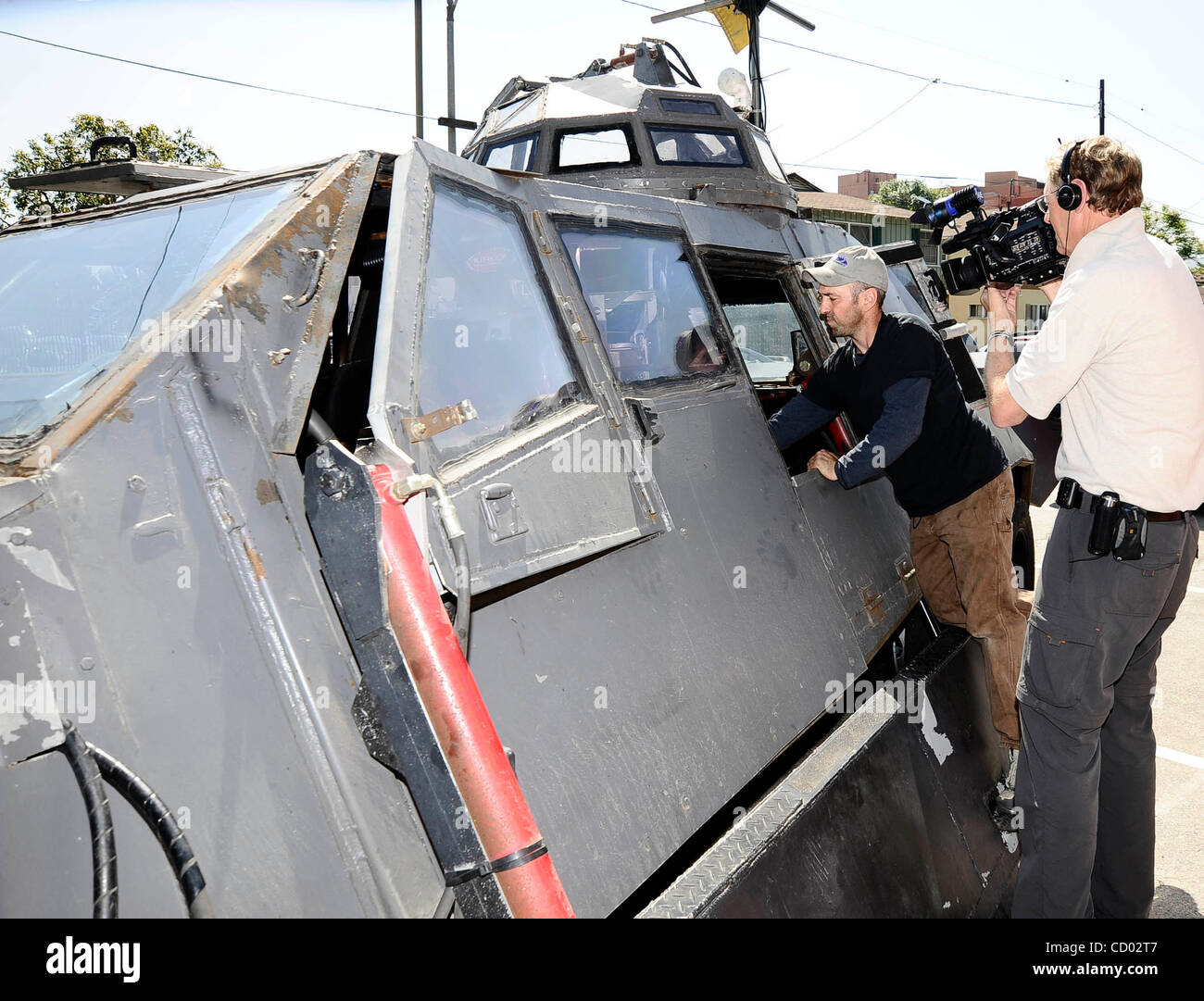 IMAX filmmaker, Sean Casey, inspects the undercarriage of his modified Ford  pickup TIV Tornado Intercept Vehicle in a hotel parking lot Thursday, May  18, 2006 in Salina, Kan. Casey wants to drive