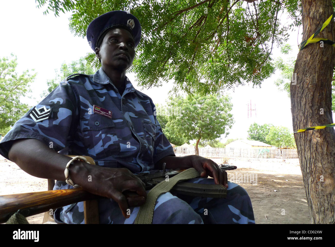 Apr 12, 2010 - Rumbek, Sudan - An armed Southern Sudanese policewoman guarding an election polling station in Rumbek. Second day of voting in the country's first democratic elections in 24 years. The polls, held from April 11-13, are part of a 2005 peace agreement signed between the Arab north and t Stock Photo