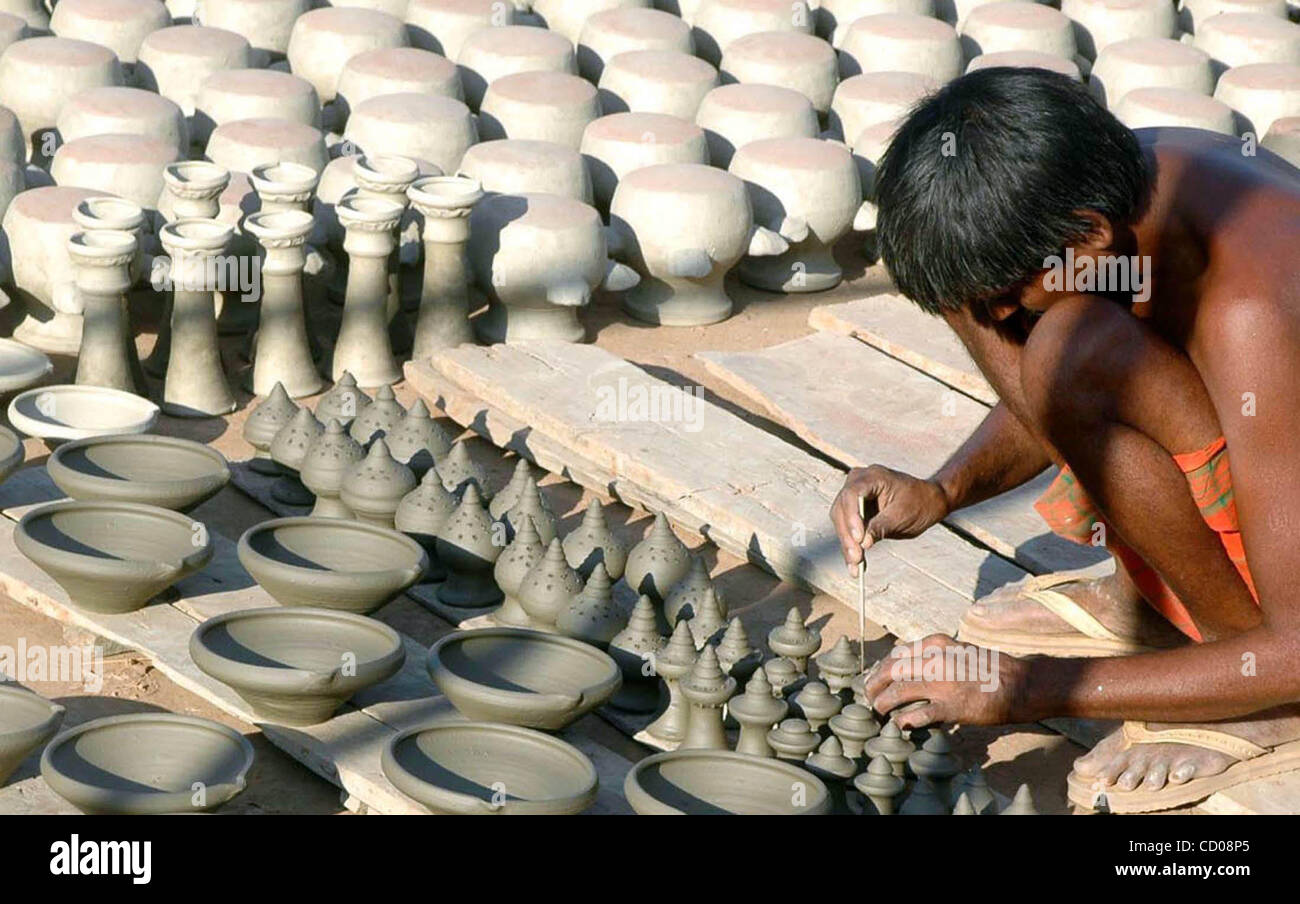 A pot maker seen busy in making Earthen lamps (saki) and Earthen pots