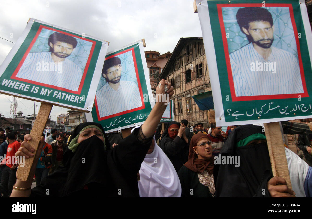A Kashmiri Muslim woman shouts slogans near pictures of a "missing ...