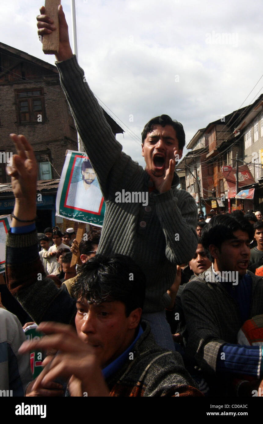 Kashmiri Muslims shouts slogans near pictures of a "missing" person ...