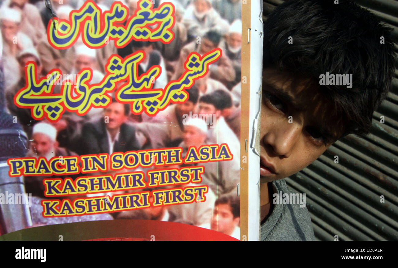 Kashmiri boy looks beside a placard(Marks Peace In South Asia Kashmir ...