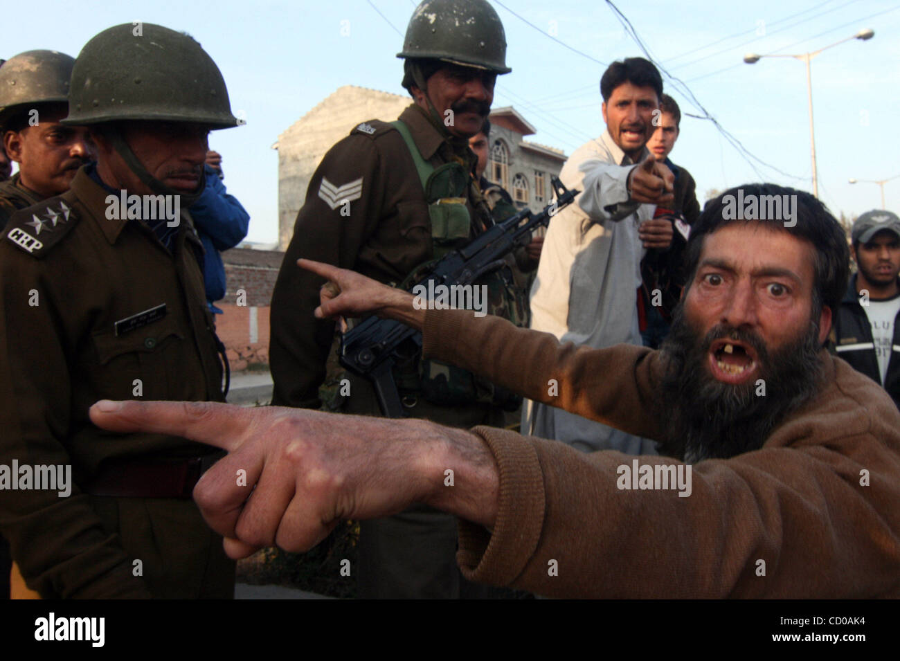 Nov 07, 2008 - Srinagar, Kashmir, India - A protester shouts at troops during a curfew in Srinagar, India. Thousands of troops in riot gear are warning people to stay indoors in an attempt to block a pro-independence rally called by separatists for a second straight day in the Indian portion of Kash Stock Photo