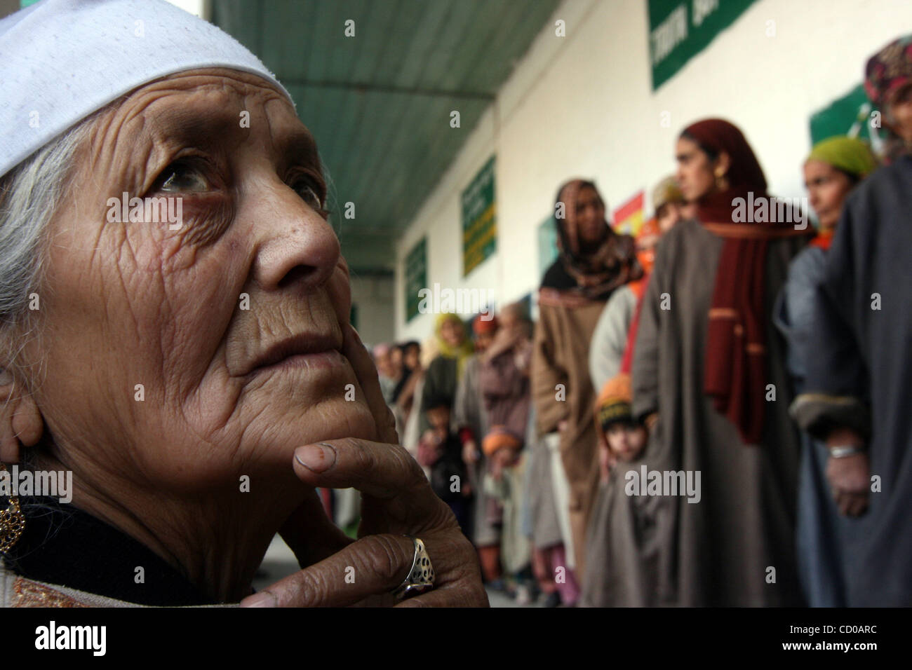 Kashmiri Muslim women wait in line at a polling station to cast their ...