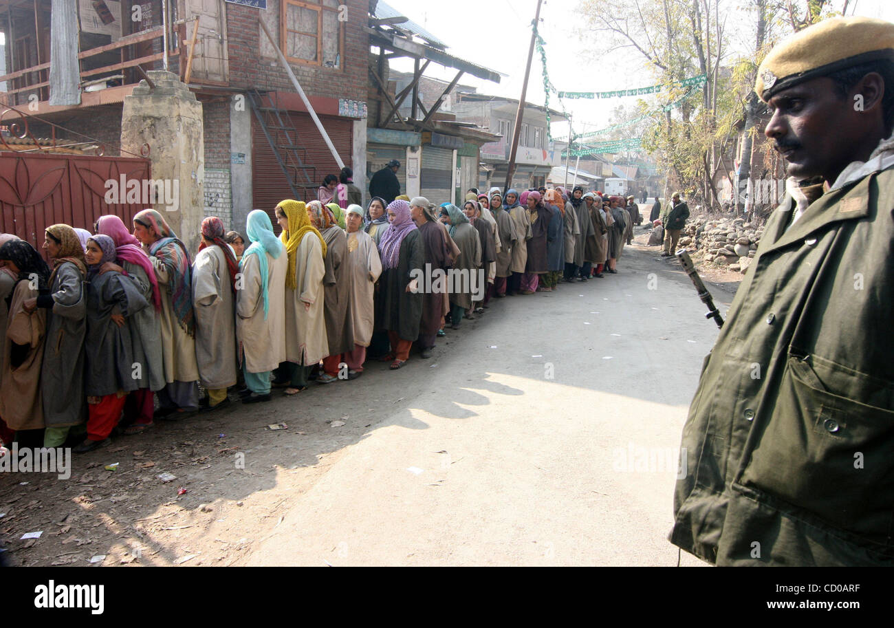 Kashmiri Muslim women wait in line at a polling station to cast their ...