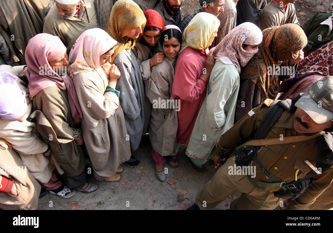 Kashmiri Muslim women wait in line at a polling station to cast their ...
