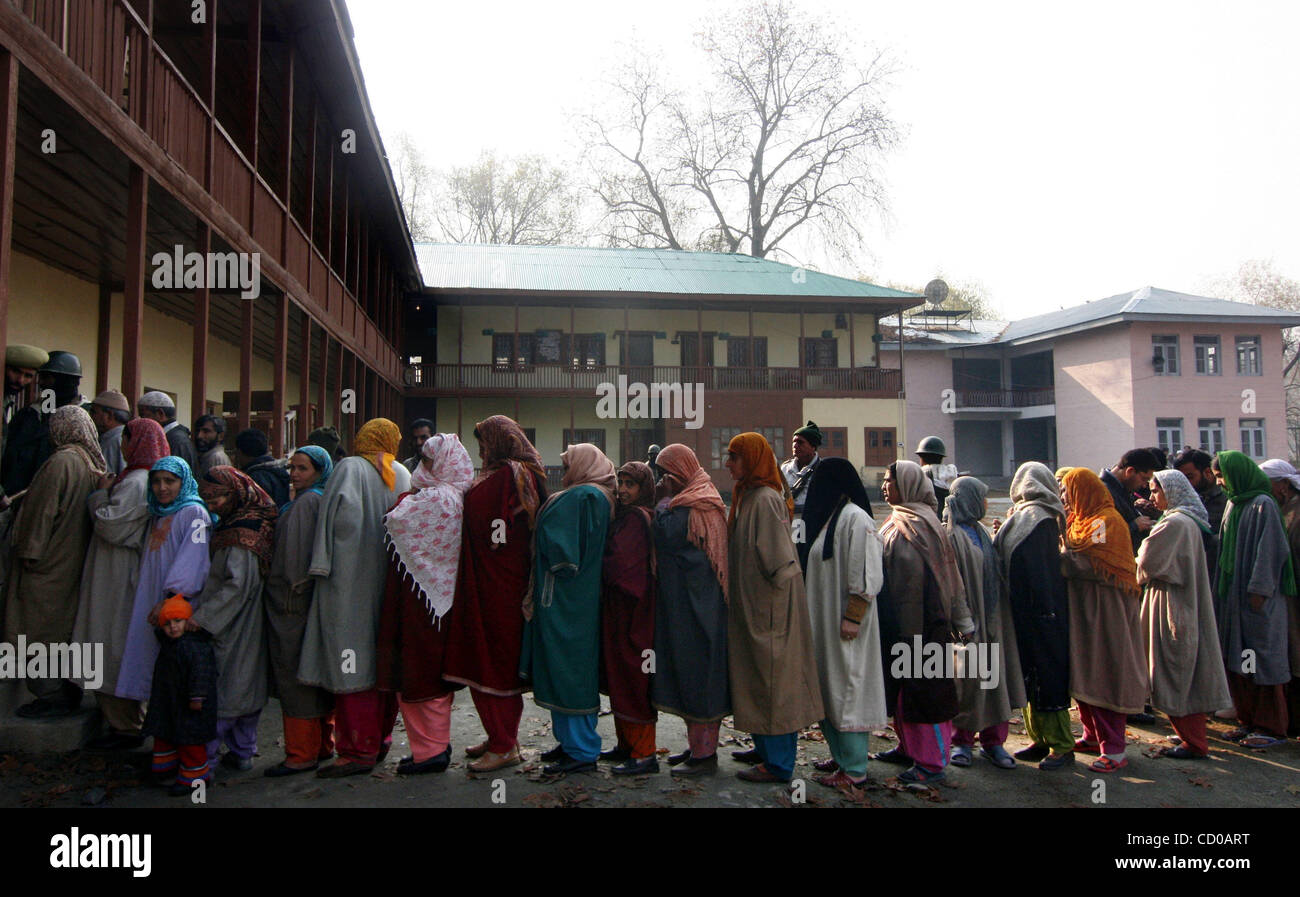 Kashmiri Muslim women wait in line at a polling station to cast their ...