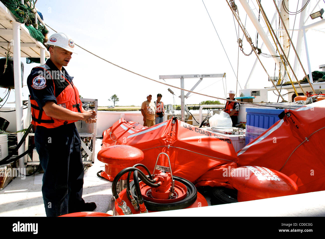 United States Coast Guard Petty Officer Nathan Lafriniere explains how local fishermen will help with the clean of the oil spill in the Gulf of Mexico on board the ship 'Miss Jasmine' during a press conference in Bayou La Batre, Alabama USA on May 9 2010.  The press conference was held by Deepwater  Stock Photo