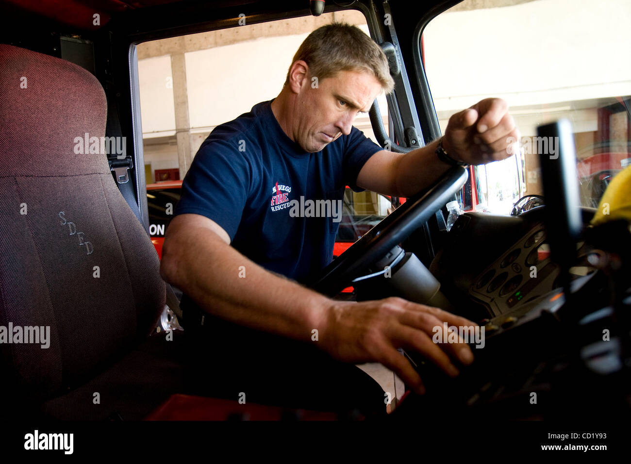 November 5, 2008 San Diego California USA Engineer Scott Fuller  does a 'pre trip' equipment check on Truck 10 at  Fire Station 10 at 4605 62nd Street in Rolando. Under the purposed budget cuts the 2 crews (either a Engine or Truck crew) per day would not be staffed on a rotating basis among the dou Stock Photo