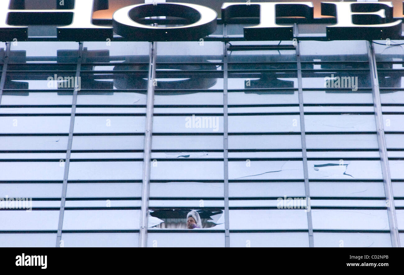 A guest at the Omni Hotel at the CNN Center peers out the shattered window of her guest room after an apparent tornado ripped through the downtown district in Atlanta, Georgia, on Saturday, March 15, 2008. State officials have put the damage estimates at least $150 million.(Credit Image: © Erik Less Stock Photo