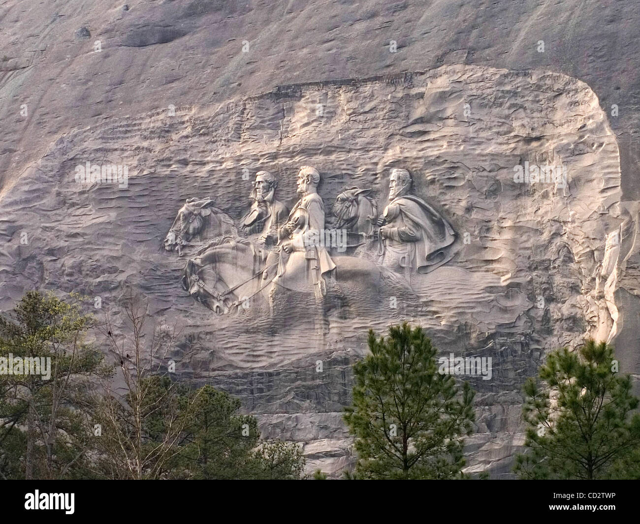 The images of Confederate President Jefferson Davis, and Confederate General's Robert E. Lee and Thomas 'Stonewall' Jackson, are illuminated by the Easter sunrise at Stone Mountain, Ga. The world's largest piece of exposed granite, Stone Mountain rises 1,863-feet above sea level and it is home to th Stock Photo
